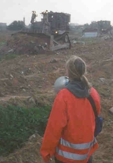 Rachel Corrie stands before Israeli IDF Caterpillar D9 bulldozers. She is wear a bright orange jacket and holding a bullhorn. By Joe Carr. joecarr@riseup.net is the email address found on the biographical info page: http://www.lovinrevolution.org/Bio.htm - archived here. See index by date.derivative work: Gobonobo (talk) - Rachel_Corrie_2003_March_16.jpg. Original source is http://www.lovinrevolution.org/rachel_pictures.htm - archived here. See index by date., Copyrighted free use, https://commons.wikimedia.org/w/index.php?curid=10552803